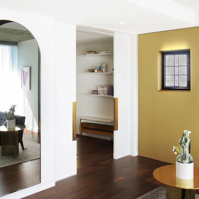 Pocket door hardware installed in a residential hallway, frame and track visible as the door slides open